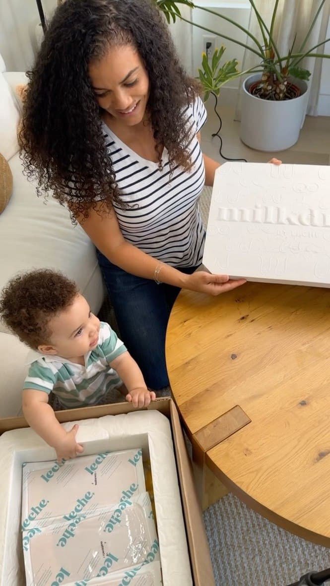 A mother and baby with a Leche box
